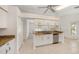 Bright kitchen featuring white cabinets, granite countertops, and stainless steel appliances at 1145 Almondwood Dr, Trinity, FL 34655