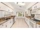 Well-lit kitchen with stainless steel appliances, granite countertops and adjacent breakfast nook at 1145 Almondwood Dr, Trinity, FL 34655