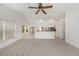 Open floor plan living room, carpeted, with breakfast bar to kitchen at 1145 Almondwood Dr, Trinity, FL 34655