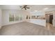 Spacious living room with neutral carpet, connecting seamlessly to the kitchen area at 1145 Almondwood Dr, Trinity, FL 34655