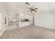 Spacious living area with neutral carpet, ceiling fan and an open view to kitchen area at 1145 Almondwood Dr, Trinity, FL 34655