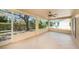 Covered screened lanai featuring tile floors, a ceiling fan, and a pleasant backyard view at 1145 Almondwood Dr, Trinity, FL 34655
