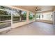 Screened porch overlooking backyard with lush landscaping at 1145 Almondwood Dr, Trinity, FL 34655