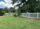 Fenced backyard with mature trees and tropical plants at 10308 Holland Rd, Riverview, FL 33578