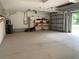 Garage interior with shelving and lawn equipment at 10308 Holland Rd, Riverview, FL 33578