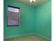 Bedroom with light teal walls and neutral carpeting at 10308 Holland Rd, Riverview, FL 33578