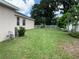 Backyard view of home's exterior and a grassy lawn at 10308 Holland Rd, Riverview, FL 33578