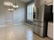 Kitchen area with stainless steel refrigerator and view to dining room at 10308 Holland Rd, Riverview, FL 33578
