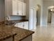 Kitchen features granite countertops and white cabinets at 10308 Holland Rd, Riverview, FL 33578