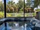 Hot tub in a screened patio overlooking the backyard at 10308 Holland Rd, Riverview, FL 33578