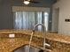 Modern kitchen sink and faucet with granite countertop at 10308 Holland Rd, Riverview, FL 33578