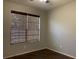 Simple bedroom with dark wood floors and a large window at 10308 Holland Rd, Riverview, FL 33578