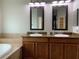 Double vanity bathroom with granite countertop, large soaking tub, and walk-in shower at 10308 Holland Rd, Riverview, FL 33578