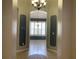 Elegant entryway with arched doorways and a chandelier at 10308 Holland Rd, Riverview, FL 33578