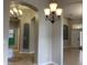Spacious hallway with tile flooring and elegant light fixtures at 10308 Holland Rd, Riverview, FL 33578