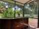 Unique wet bar with wood detail in the screened patio at 10308 Holland Rd, Riverview, FL 33578