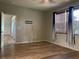 Bedroom with hardwood floors, neutral walls, and blue curtains at 10308 Holland Rd, Riverview, FL 33578