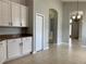 Bright kitchen with white cabinets and granite countertops at 10308 Holland Rd, Riverview, FL 33578
