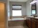 Oval soaking tub, double vanity, and walk-in closet at 10308 Holland Rd, Riverview, FL 33578