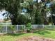 Landscaped backyard with lush greenery and white fence at 10308 Holland Rd, Riverview, FL 33578