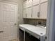 Laundry room with white cabinets and washer/dryer hookups at 10308 Holland Rd, Riverview, FL 33578