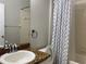 Bathroom with granite countertop, shower/tub combo, and a patterned shower curtain at 10308 Holland Rd, Riverview, FL 33578
