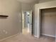 Bedroom with neutral walls, carpeting, and a view of the laundry room at 10308 Holland Rd, Riverview, FL 33578