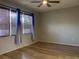 Bedroom with hardwood floors, neutral walls, and blue curtains at 10308 Holland Rd, Riverview, FL 33578