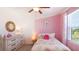 Charming bedroom with flamingo bedding and a pink accent wall at 5018 Captain Davis Dr, Wimauma, FL 33598