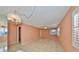 Living room with light peach walls, tile floors, and plantation shutters at 5975 Terrace Park N Dr # 211, St Petersburg, FL 33709