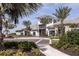 Modern clubhouse with palm trees and lush landscaping at 4712 Garofalo Rd, Wesley Chapel, FL 33545