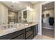 Elegant bathroom with double vanity, large mirror, and walk-in closet at 4712 Garofalo Rd, Wesley Chapel, FL 33545