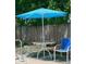 Relaxing poolside patio furniture with umbrella at 10921 Temple Ave, Seminole, FL 33772