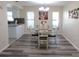 Dining room featuring new floors, lighting fixture, and access to kitchen at 2501 Lonigan Pl, Sun City Center, FL 33573