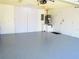 This is a well-kept garage area with grey epoxy flooring and white walls at 2501 Lonigan Pl, Sun City Center, FL 33573
