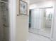 Bathroom access hallway showing glass shower on left and closet with mirrored doors on right at 2501 Lonigan Pl, Sun City Center, FL 33573