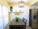 Kitchen nook featuring new floors, cabinets and a stainless steel refrigerator at 2501 Lonigan Pl, Sun City Center, FL 33573