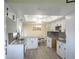 Kitchen featuring new floors, white cabinets, stainless appliances, and granite countertops at 2501 Lonigan Pl, Sun City Center, FL 33573