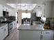 Kitchen with new floors, white cabinets, stainless steel appliances, and granite countertops at 2501 Lonigan Pl, Sun City Center, FL 33573