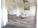Living room with new floors featuring a chair and artwork on the walls at 2501 Lonigan Pl, Sun City Center, FL 33573