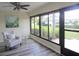 Sun Room with new floors featuring large windows and a chair at 2501 Lonigan Pl, Sun City Center, FL 33573