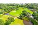 An aerial view of a lush golf course, featuring ponds and bridges at 5733 Pawnee St, Zephyrhills, FL 33542