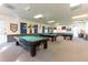 The billiards room features multiple well-maintained pool tables, soft lighting, and comfortable seating, ideal for recreation at 5733 Pawnee St, Zephyrhills, FL 33542