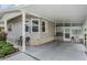 Home's covered carport features a cozy sitting area and access to the enclosed front porch at 5733 Pawnee St, Zephyrhills, FL 33542