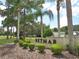 Landscaped entrance to Betmar community, featuring manicured bushes, trees and brick signage at 5733 Pawnee St, Zephyrhills, FL 33542