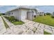 Well-maintained home with a private driveway, exterior storage, and neat landscaping, creating curb appeal at 5733 Pawnee St, Zephyrhills, FL 33542