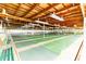 Spacious recreation hall with shuffleboard courts, picnic tables, and ceiling fans at 5733 Pawnee St, Zephyrhills, FL 33542