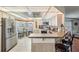 Bright kitchen boasts modern stainless steel appliances and an adjacent breakfast bar at 5733 Pawnee St, Zephyrhills, FL 33542