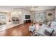 Spacious living room features hardwood floors and large windows for plenty of natural light at 5733 Pawnee St, Zephyrhills, FL 33542