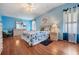Nautical main bedroom showcasing seaside colors, matching furniture, and hardwood floors at 5733 Pawnee St, Zephyrhills, FL 33542